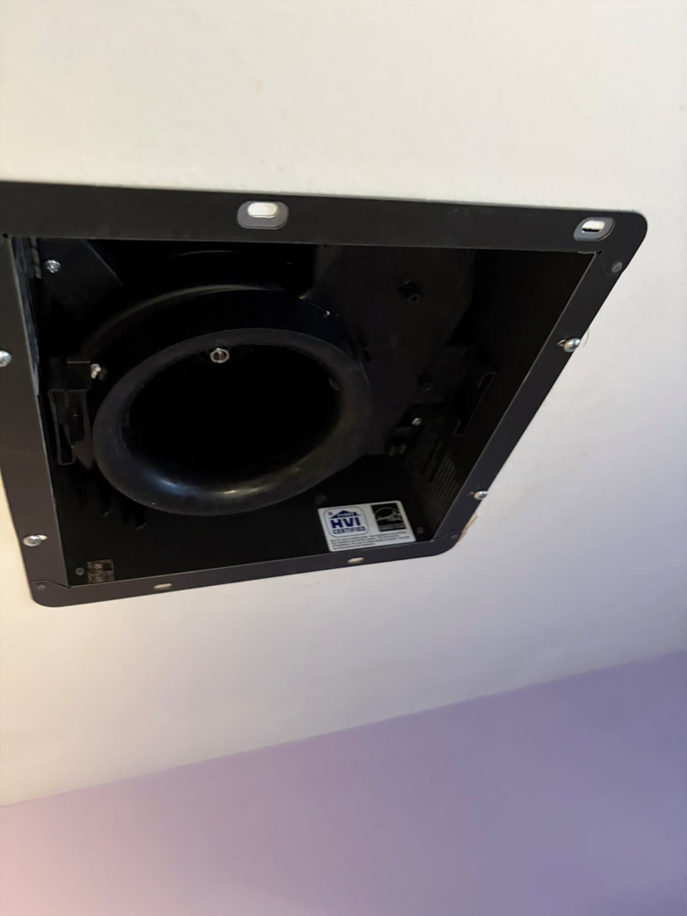 Old loose bathroom fan in the ceiling
