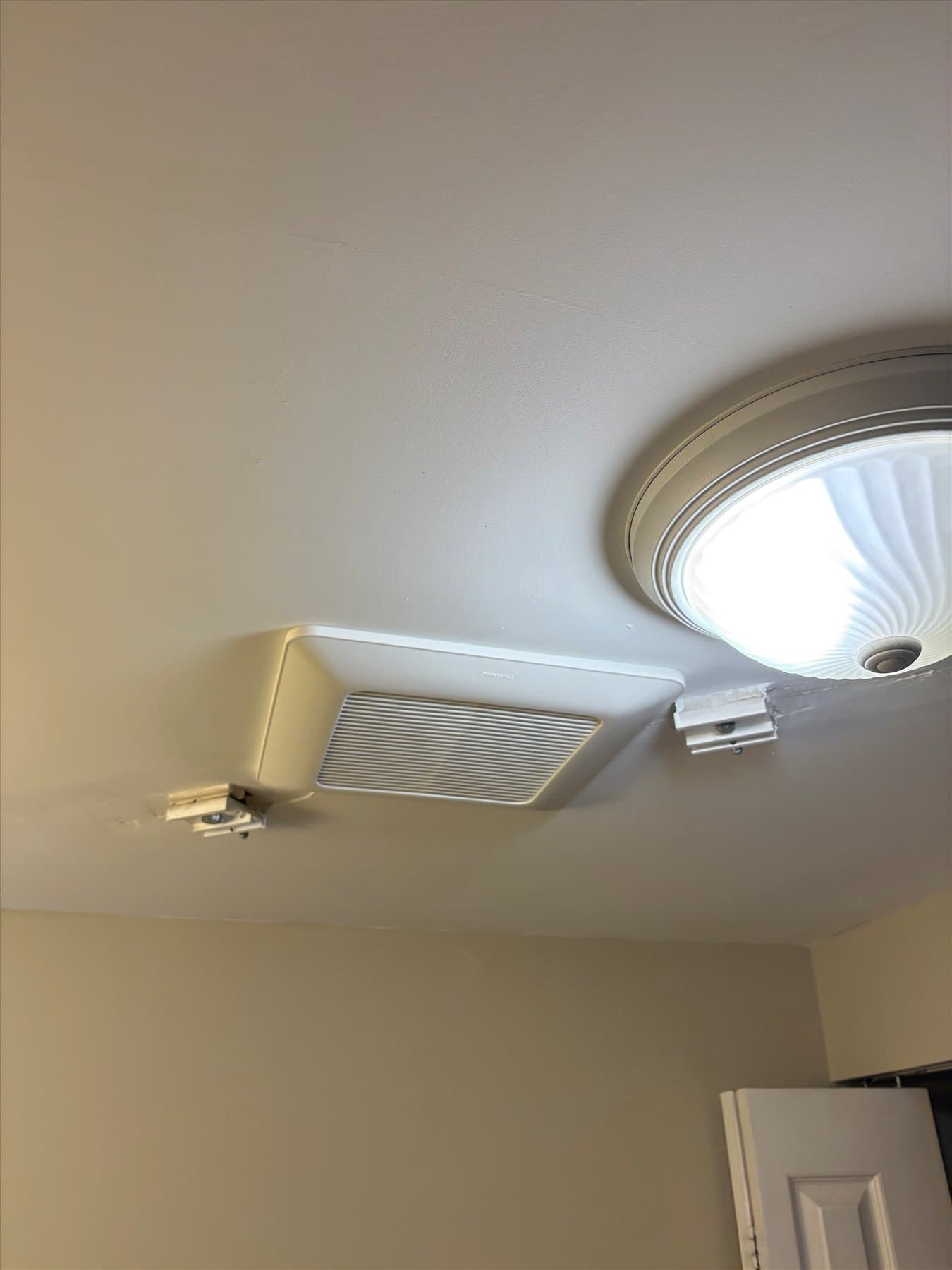 Old ceiling fixture in an accessible Fairview bathroom