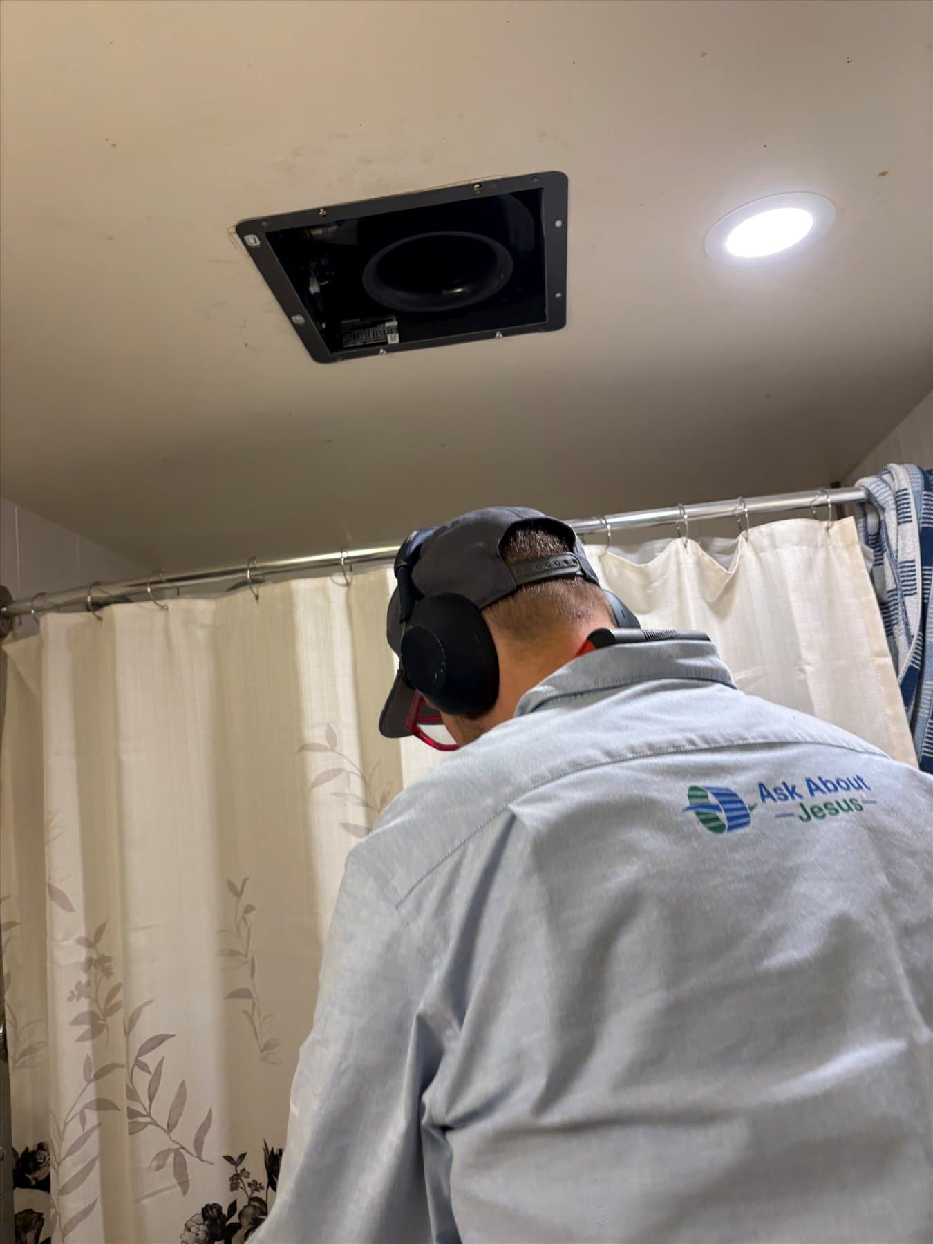 Bathroom Fan Pros installer removing the old Marpole fan
