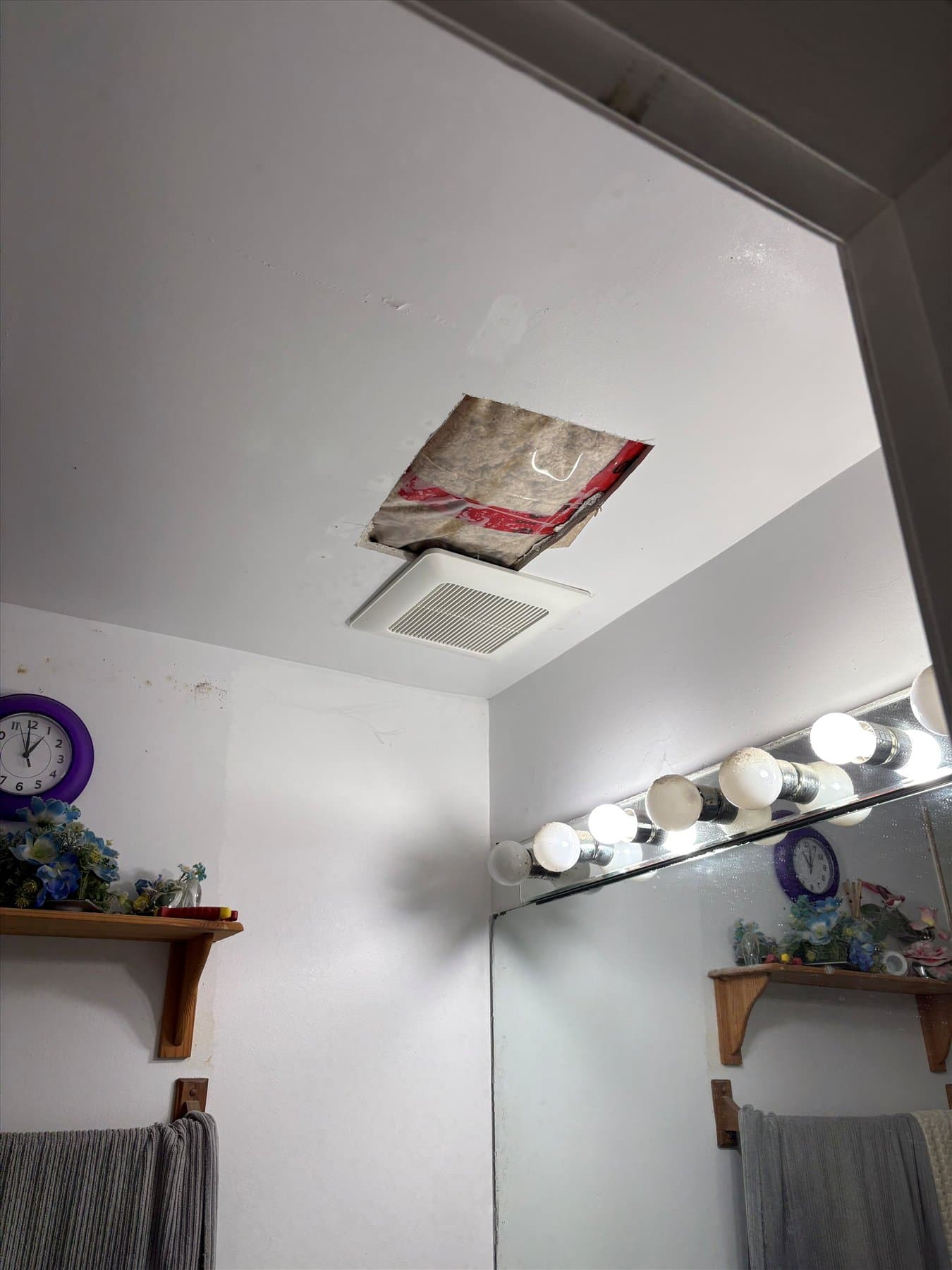 Bathroom ceiling opening after removal of the failed fan