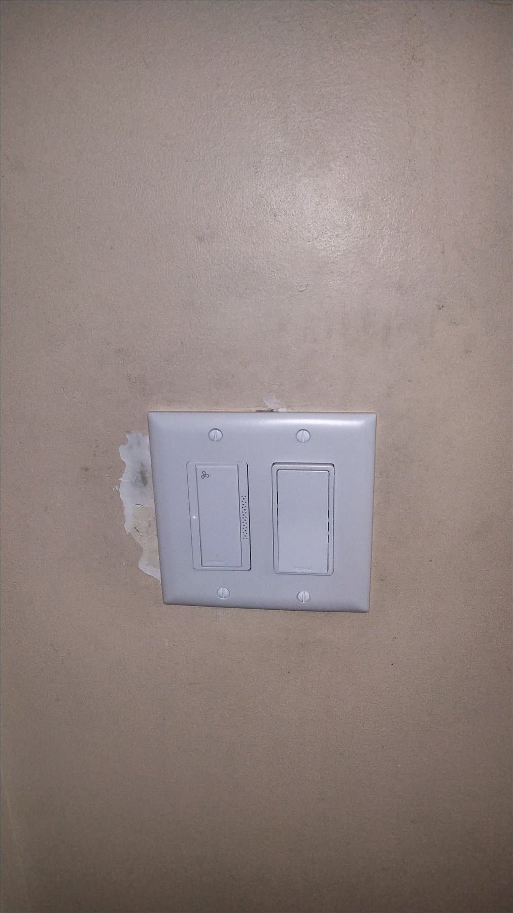 Bathroom fan installer working at the ceiling in Willoughby Heights