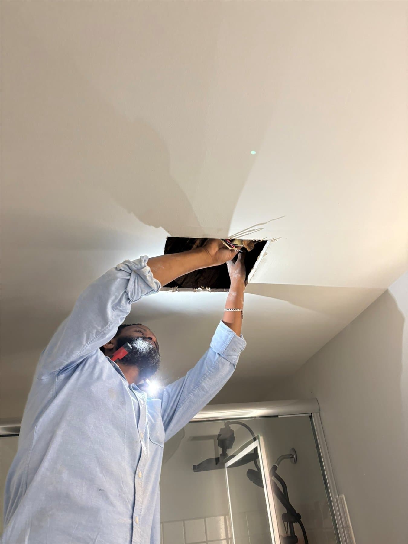 Installer opening the East Vancouver bathroom fan location