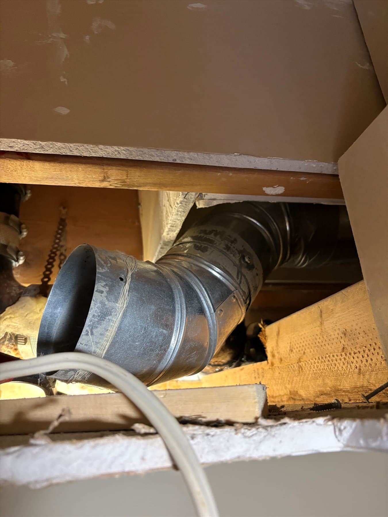 Bathroom fan duct connection above the ceiling