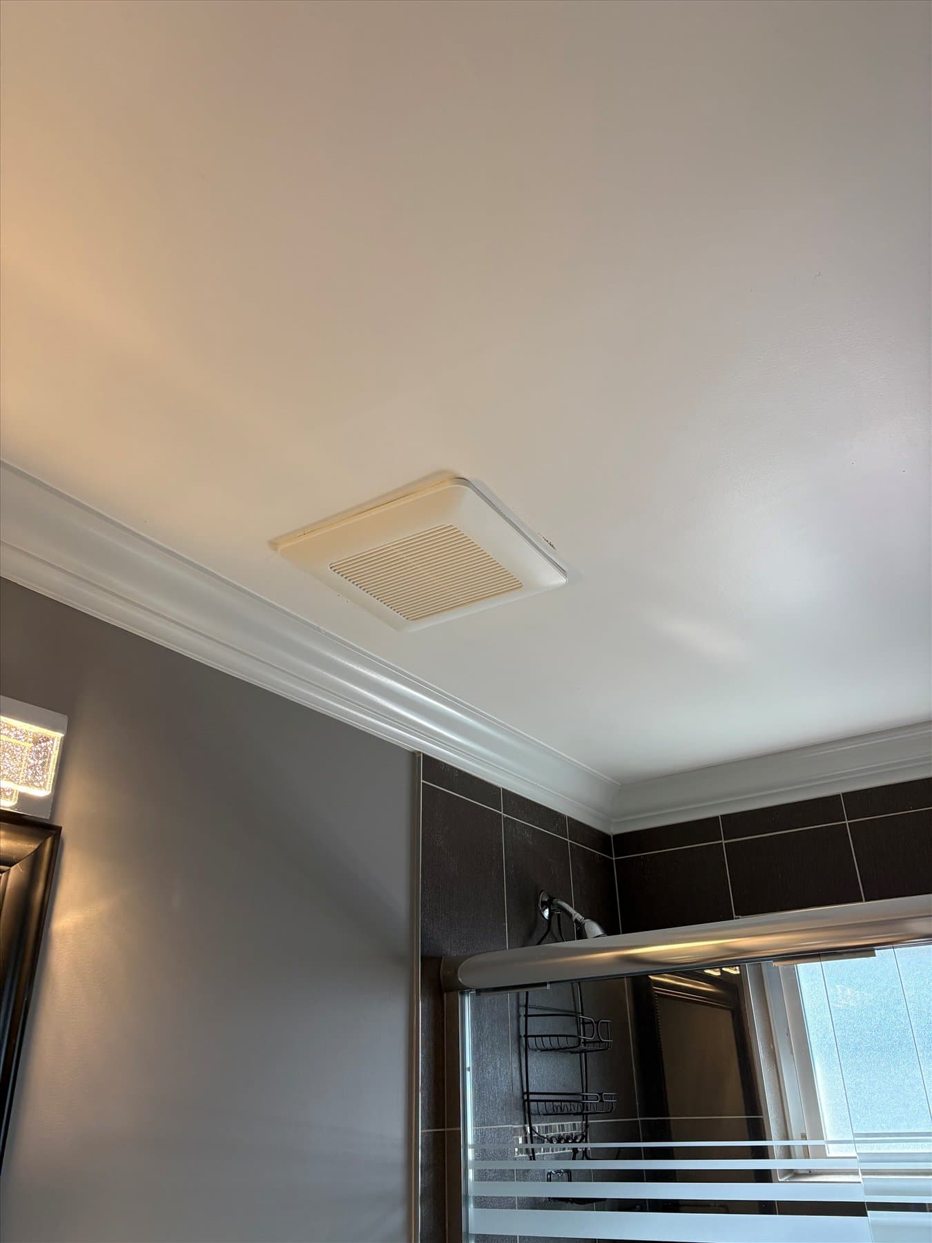 Old builder-grade bathroom fan grille