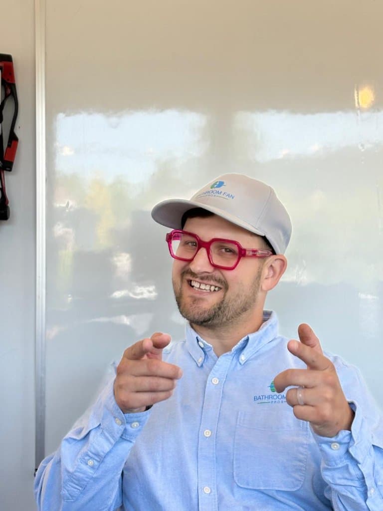 Bathroom Fan Pros founder pointing toward the viewer