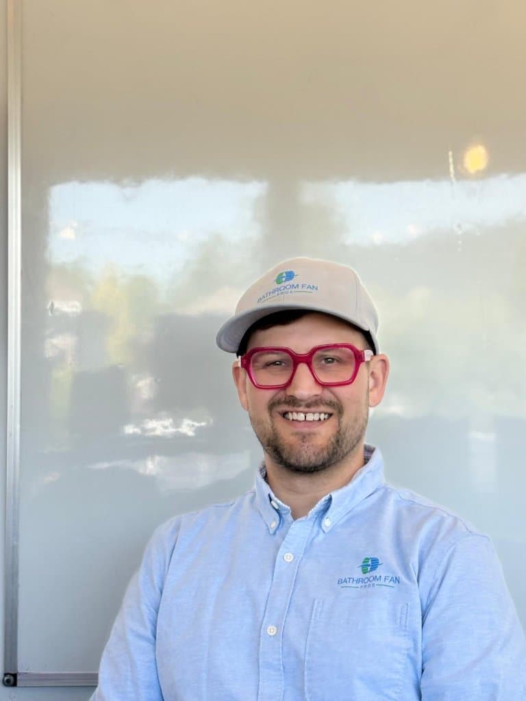 Bathroom Fan Pros founder smiling in company uniform